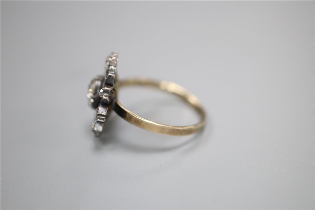 An antique yellow metal and diamond set circular cluster ring, (adapted?), size K/L, gross 3.5 grams,